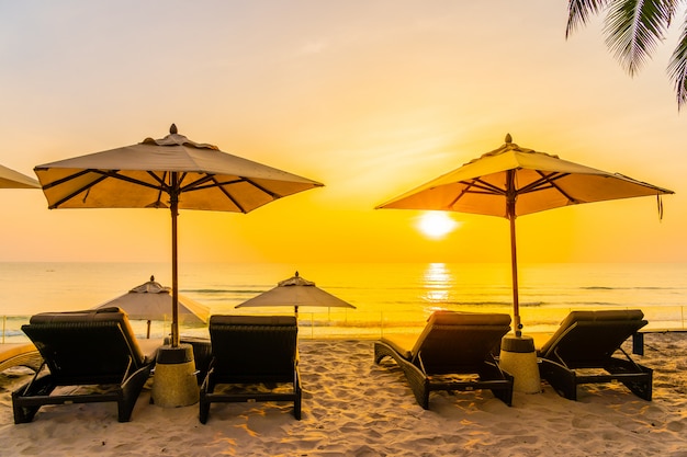 Beautiful Beach and Sea at Sunrise: Umbrella and Chair for Travel and Vacation – Free Download