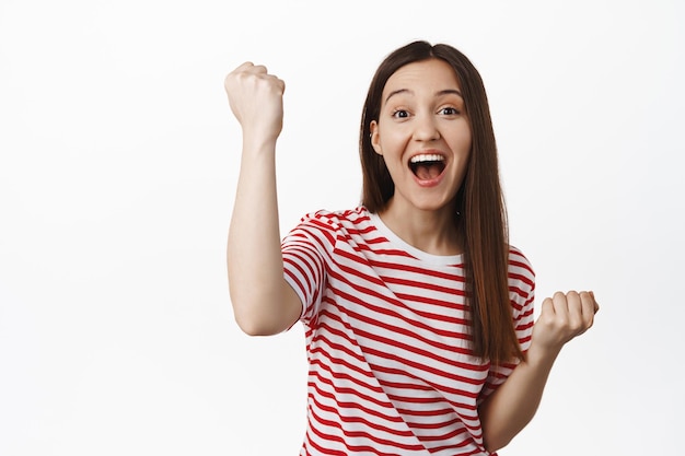 Excited Brunette Girl Cheering and Celebrating Victory – Free Stock Photo for Download