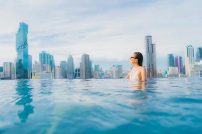 Beautiful Young Asian Woman Relaxing and Smiling by Swimming Pool – Free Stock Photo for Download