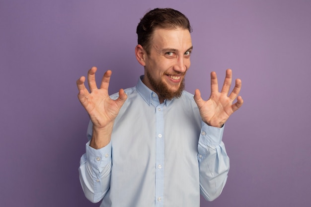 Joyful Handsome Blonde Man Gesturing Tiger Paws on Purple Wall – Free Download