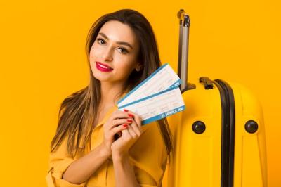 Smiling Woman Holding Plane Tickets – Free Download