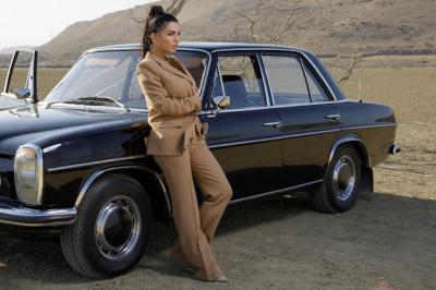 Young Girl in Brown Suit Leaning on Car in the Desert – Free Download