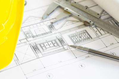 Construction Plans Featuring Yellow Helmet and Drawing Tools – Free to Download