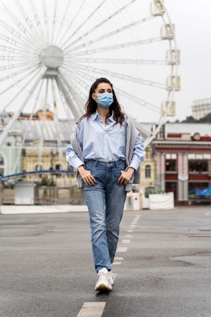 Woman Posing in an Amusement Park with a Medical Mask – Free Stock Photo, Download for Free