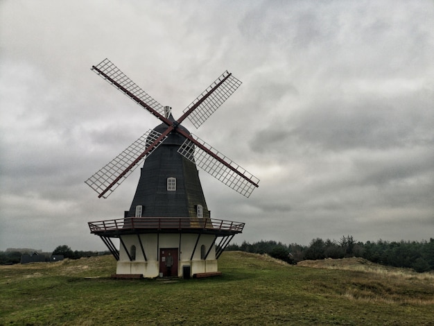 Wide Angle Shot of a Windmill Under a Sky Full of Clouds – Free Download