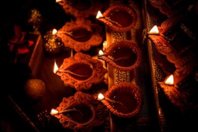 Diwali diya lighting at night with gifts and flowers – free stock photo, download for free