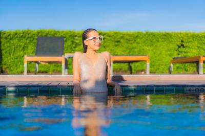 Beautiful Young Asian Woman Relaxing by Outdoor Swimming Pool at Hotel Resort – Free Download