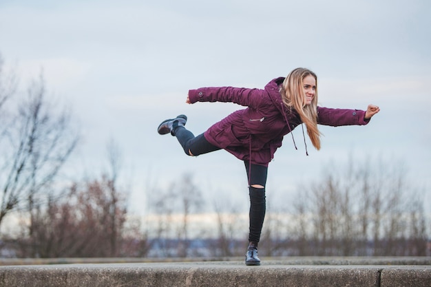 Woman Posing on a Wall – Free Stock Photo for Download