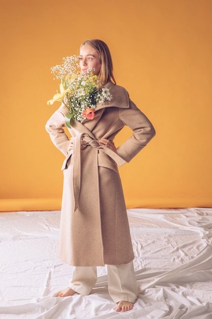 Thoughtful Young Woman Holding a Flower Bouquet – Free to Download