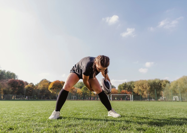 Sportive Girl Holding a Rugby Ball – Free Download