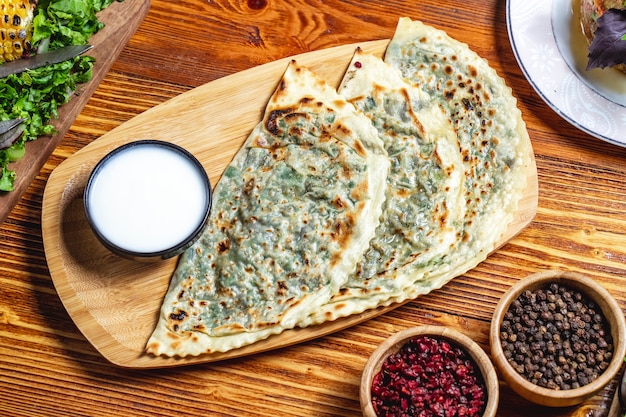 Qutab with Greens, Yogurt, Dried Barberry, and Black Pepper on a Table – Free Stock Photo for Download