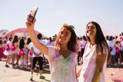 Happy Young Woman Taking Selfie at Holi Festival – Free Stock Photo for Download