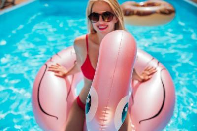 Woman Sitting on Flamingo Swim Ring – Free Stock Photo for Download