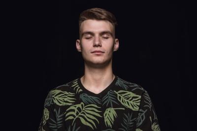 Close Up Portrait of a Young Man in a Black Studio – Free Stock Photo Download