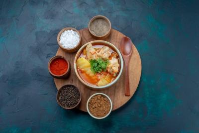 Top View of Chicken Soup and Seasonings on Dark Blue Background – Free Download