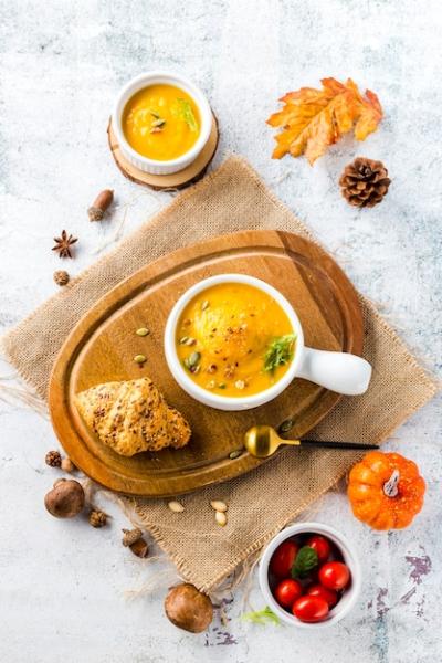 Squash Soup on Wooden Board Surrounded by Autumn Vegetables – Free Download