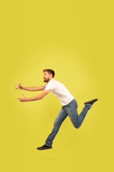 Happy Jumping Man Portrait on Yellow Wall – Free Download