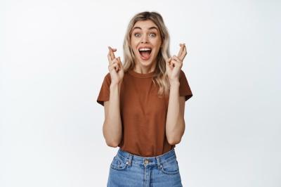 Excited Girl Screams with Crossed Fingers, Hoping to Win – Free Stock Photo for Download