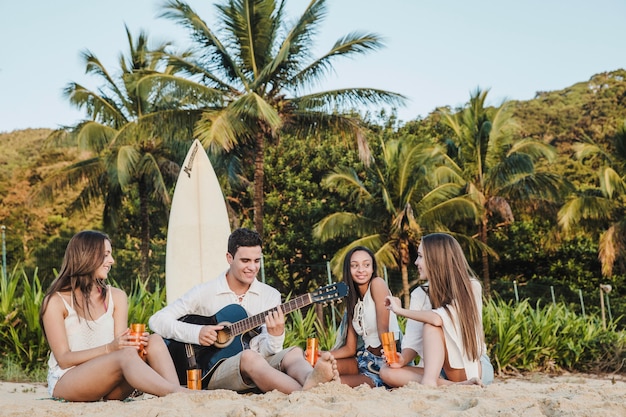 Young Friends Playing Guitar on the Beach – Free Download