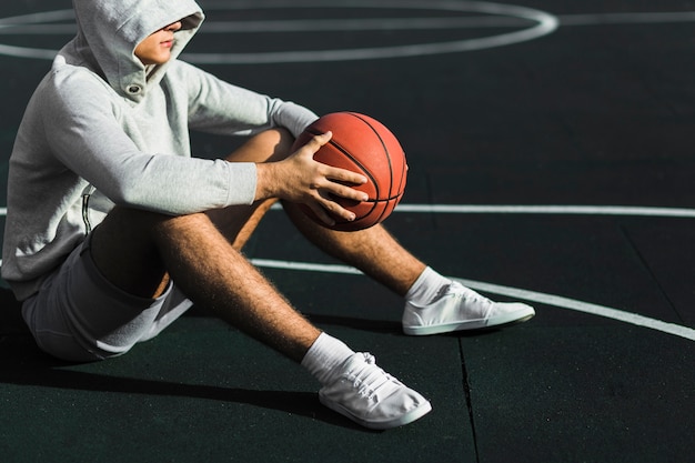 Man Sitting on Court Side View – Free Download