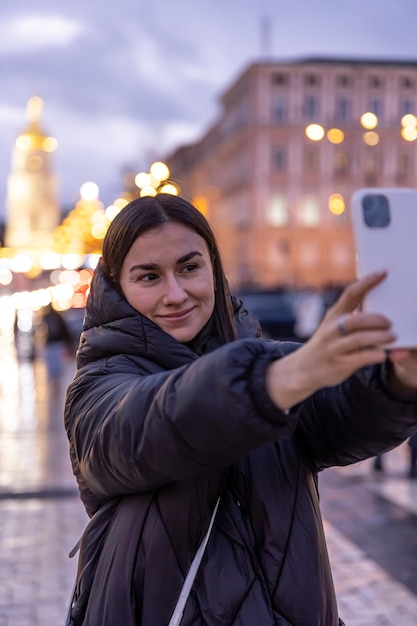 A Woman Capturing Night Cityscapes on Her Smartphone – Free Stock Photo, Download for Free