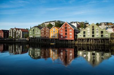 Range of Buildings on the Shore Reflecting in the Lake Under Clear Blue Sky – Free Download