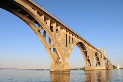 Stunning Low Angle View of Bridge Over River Against Clear Blue Sky – Free Download