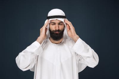 Saudi Arabian Man Posed Against Dark Blue Wall – Free Stock Photo Download