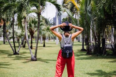 Discover Travel Moments: Happy Woman in Bangkok’s Tropical Park – Free Download