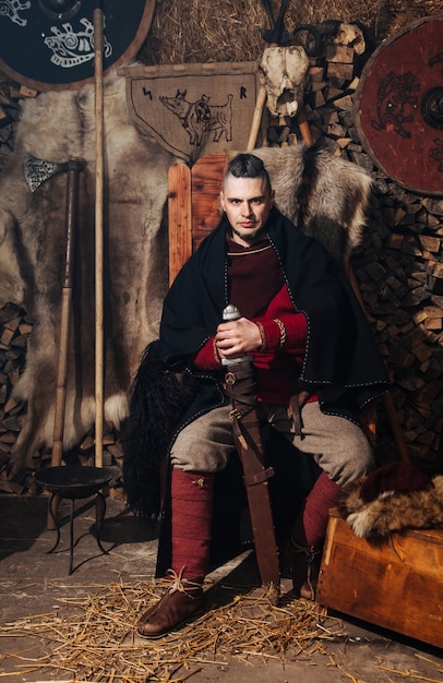 Viking Posing Against Ancient Viking Interior – Free Download