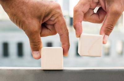 Hands Placing Cubes on Surface – Free Stock Photo for Download