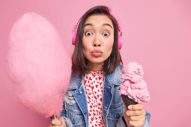 Fashionable Woman Enjoying Wireless Music with Cotton Candy and Ice Cream – Free Stock Photo for Download