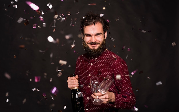 Laughing Guy with Bottle and Glasses Surrounded by Confetti – Free Download