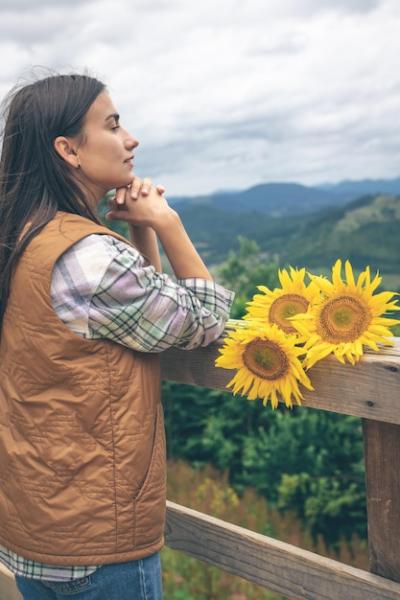 Woman Holding a Bouquet of Sunflowers in Mountain Nature – Free Download