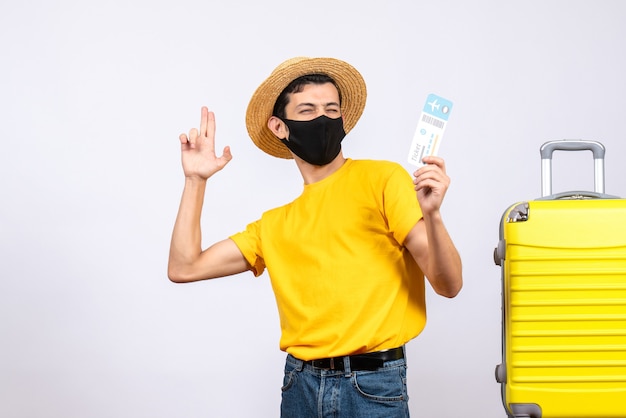 Young Man in Yellow T-Shirt with Travel Ticket and Yellow Suitcase – Free Download