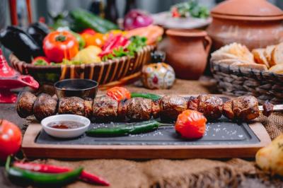 Grilled Potatoes on Shish with Vegetables and Sauces on Wooden Board – Free Download