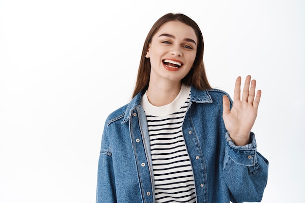 Happy Girl Waving Hello: Smiling Woman Greeting with a Warm Gesture – Free Stock Photo, Download Free