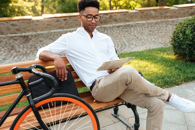 Young African Man Concentrating on Reading Newspaper – Free Stock Photo for Download