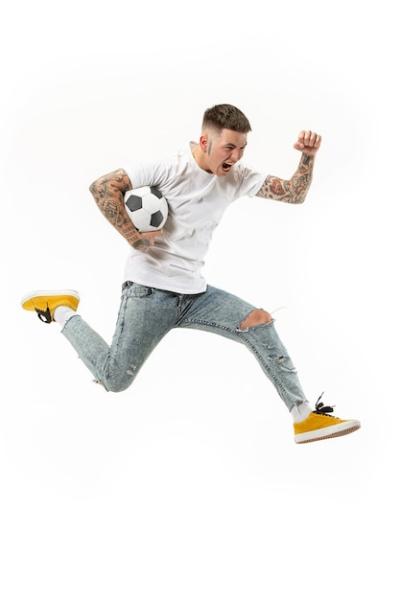 Soccer Player Jumping and Kicking the Ball in Studio – Free Stock Photo for Download