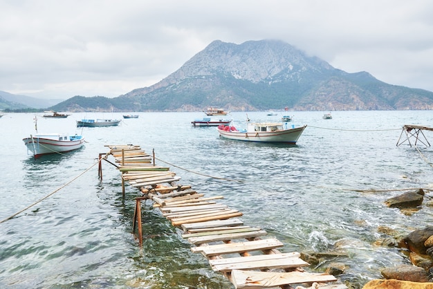 Boats by a Broken Pier in Calm Blue Waters – Free to Download