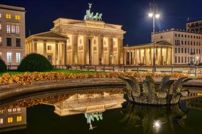 The Brandenburg Gate in Berlin at Night Reflected in a Fountain – Free Download