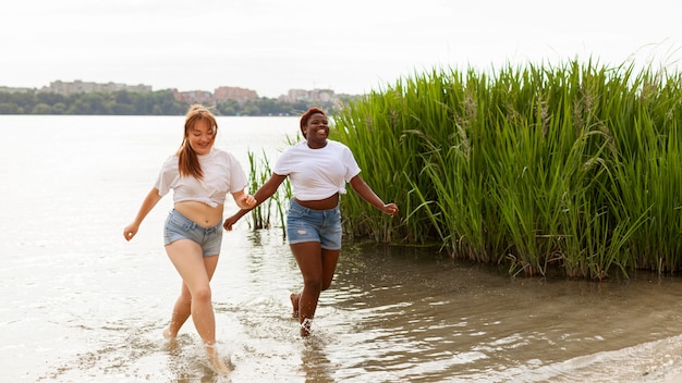 Smiling Women Enjoying a Day at the Beach – Free Stock Photo for Download