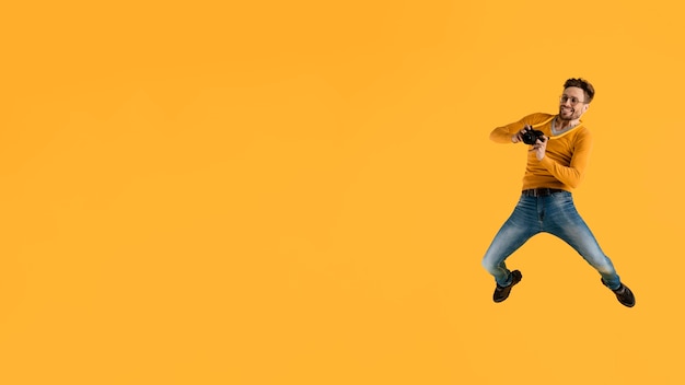 Young Man Jumping with Camera – Free Stock Photo Download