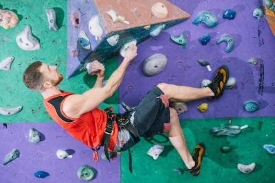 Sporty Man Climbing Wall in Gym – Free Download