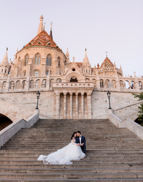 Tender Wedding Couple Sitting on Historical Stone Stairs – Free Download