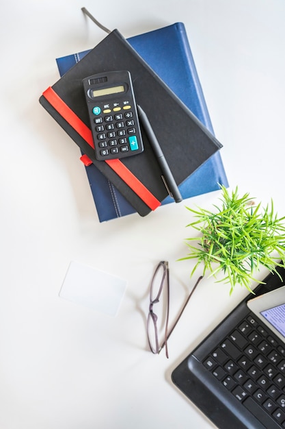 Stationery, Eyeglasses, and Potted Plant on Tabletop – Free Stock Photo for Download