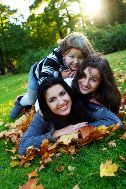 Young Family Enjoying a Healthy Stroll in an Autumn Park – Free to Download