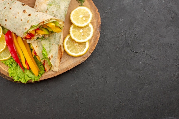 Sliced Shaurma Meat Sandwich with Lemon Slices on Black Table – Free Download