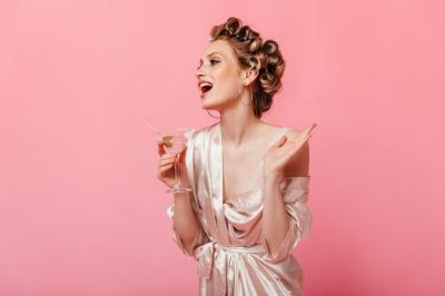 Lady Laughing with Martini Glass in Hair Curlers and Bathrobe – Free Stock Photo for Download