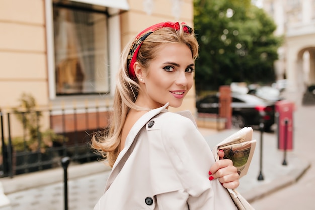 Enthusiastic Lady with Red Ribbon in Fair Hair Walking Down the Street – Free to Download